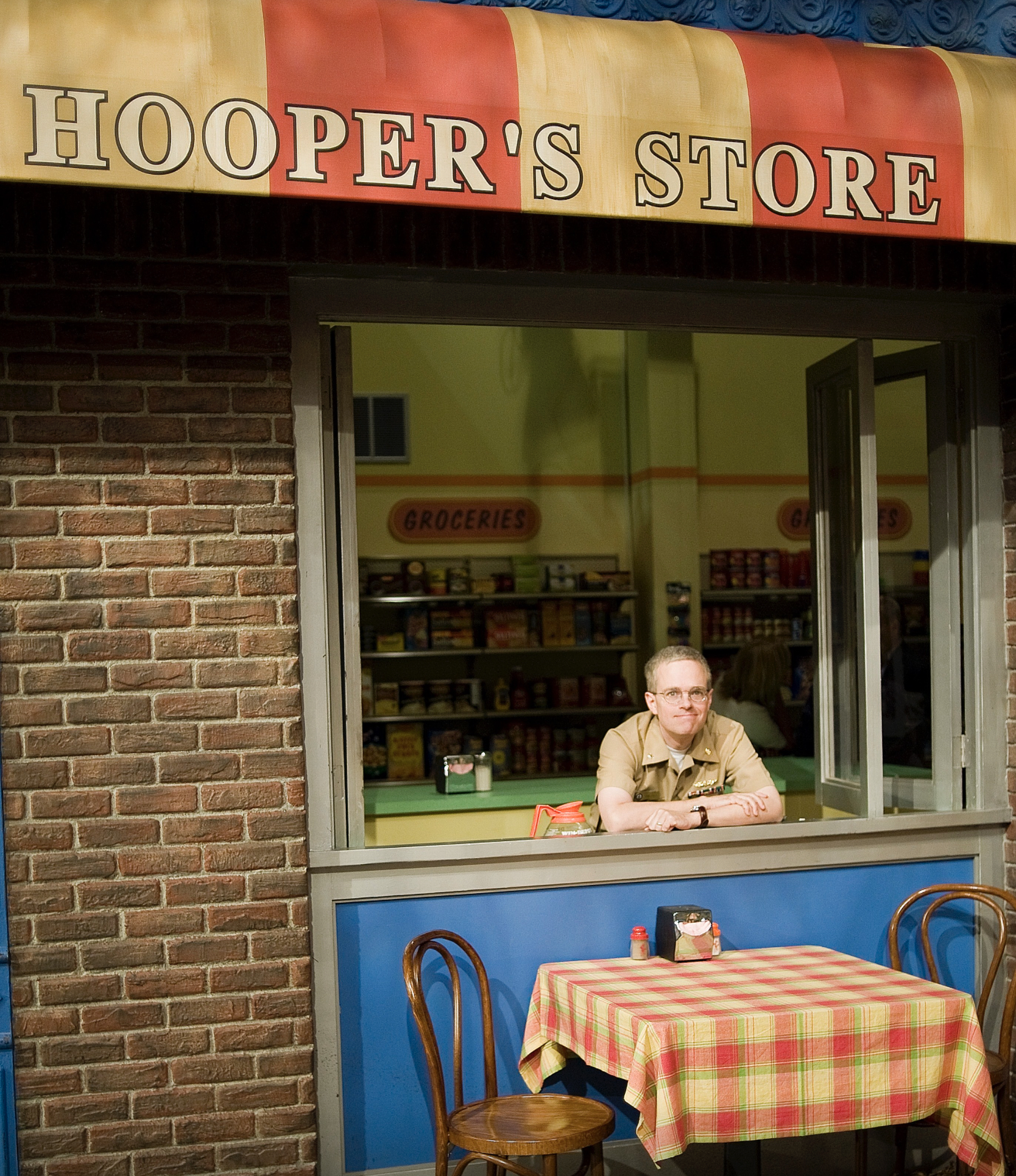 Russell Shilling standing at Hooper’s Store on Sesame Street.