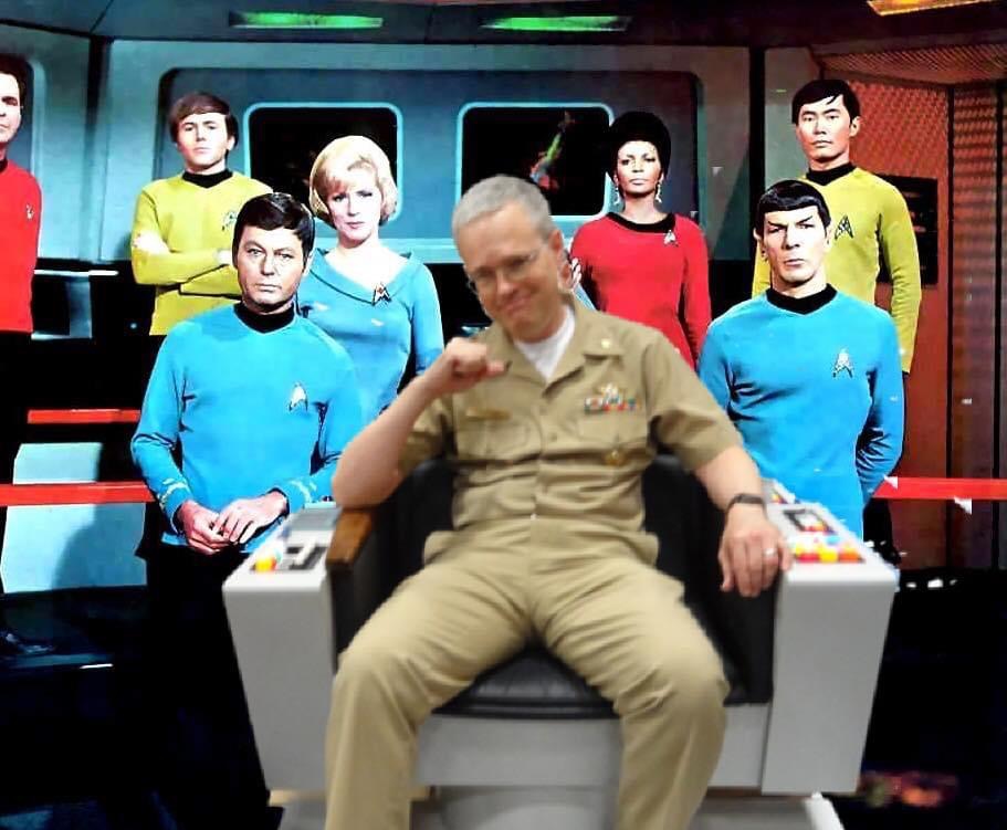 Russell Shilling seated in a Star Trek captain’s chair at a media event.